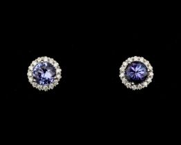 A pair of 18 karat white gold rosette stud earrings, with Tanzanite and diamonds 