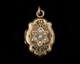 A 14 karat rose gold medallion, set with pearls