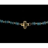 A cord of blue tourmaline with 18 karat gold lock
