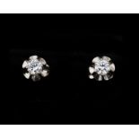 A pair of 14 karat white gold solitaire stud earrings set with brilliant ca. 0.48 ct.