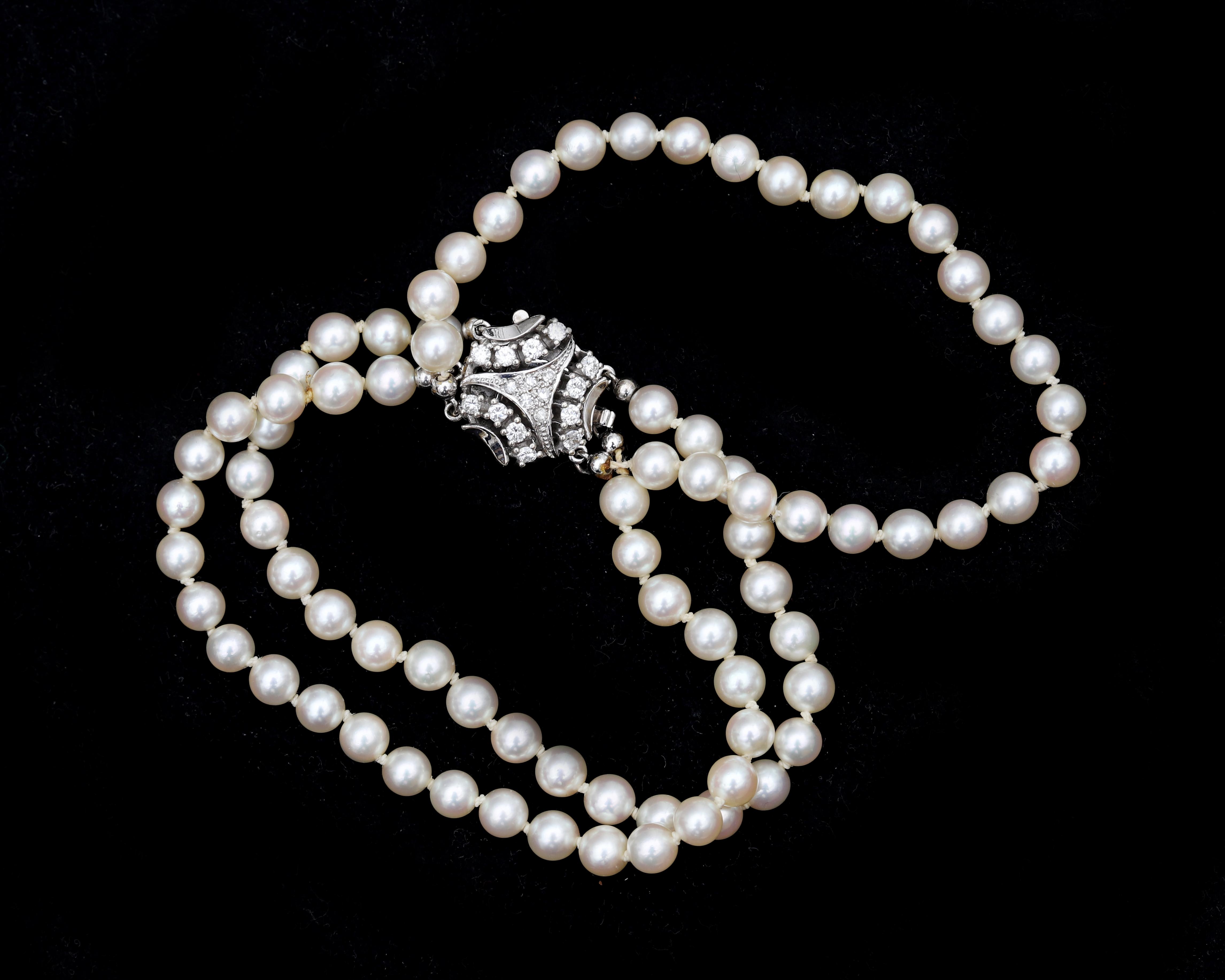 A pearl bracelet with a 14 karat white gold decorative clasp set with diamonds