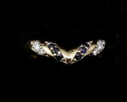 An 18 karat gold chevron ring, set with sapphires and diamonds