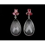 A pair of 14 karat white gold earrings set with rose quartz and six rubies