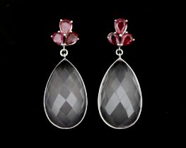 A pair of 14 karat white gold earrings set with rose quartz and six rubies