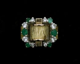 An 18 karat gold ring with diamonds and emeralds 