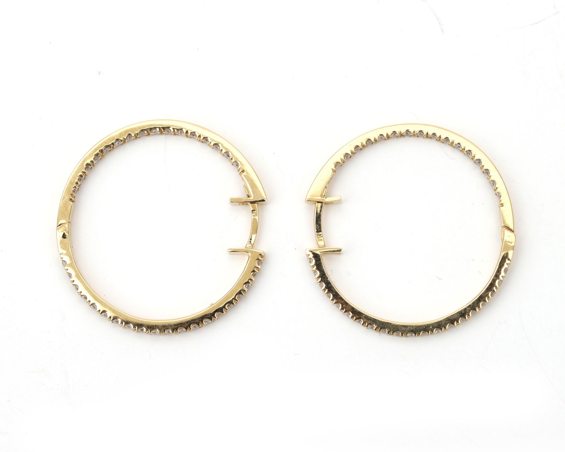 A pair of 18 karat gold earrings, pavé set with brilliant at the in and the outsite - Image 4 of 4