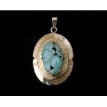 A 14 karat vintage oval pendant set with an oval jade