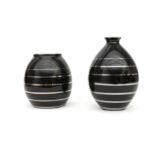 Charles Catteau (1880-1966) Two black glazed ceramic vases decorated with silvered bands, produced