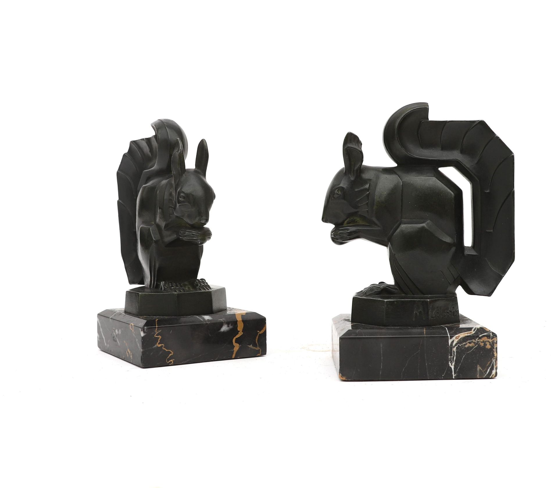 Max Le Verrier (1891-1973) A pair of bronzed metal bookends on black marble bases, both with moulded