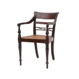 The open back with carved ornaments, webbing seat, armrests with carved details, four tapering
