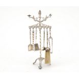 A miniature silver fireplace set, Dutch, 19th century. Crowned with candle holders, supported by