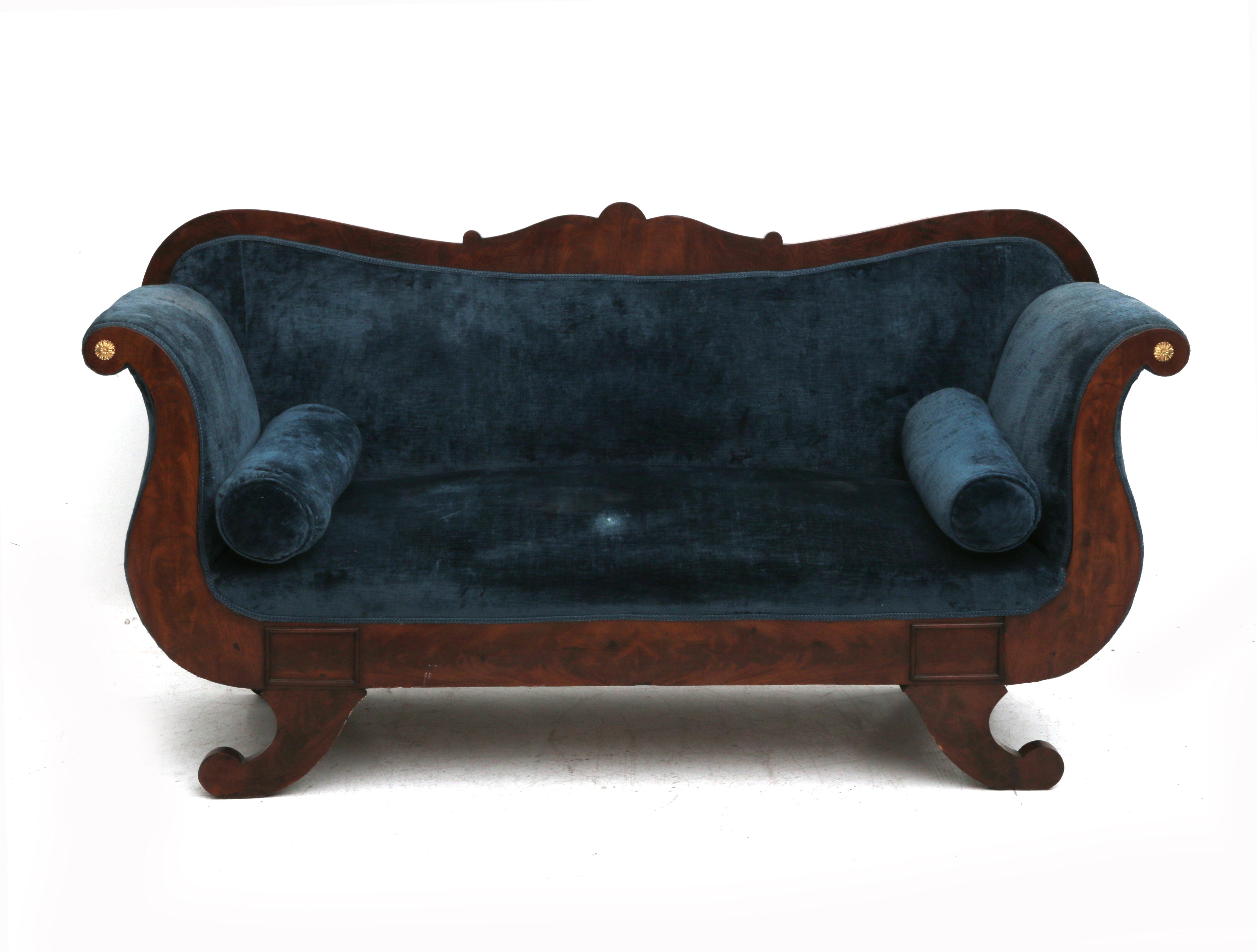 The back with carved scroll in the centre, the armrests double curved, gilt rosettes at the end,