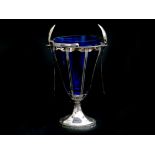 A silver sugarvase with blue glass insert, two matching silver spoons. The base engraved: '