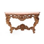 Under the scalloped marble top extensive carvings of rocaille and shell motifs, four cabriole legs