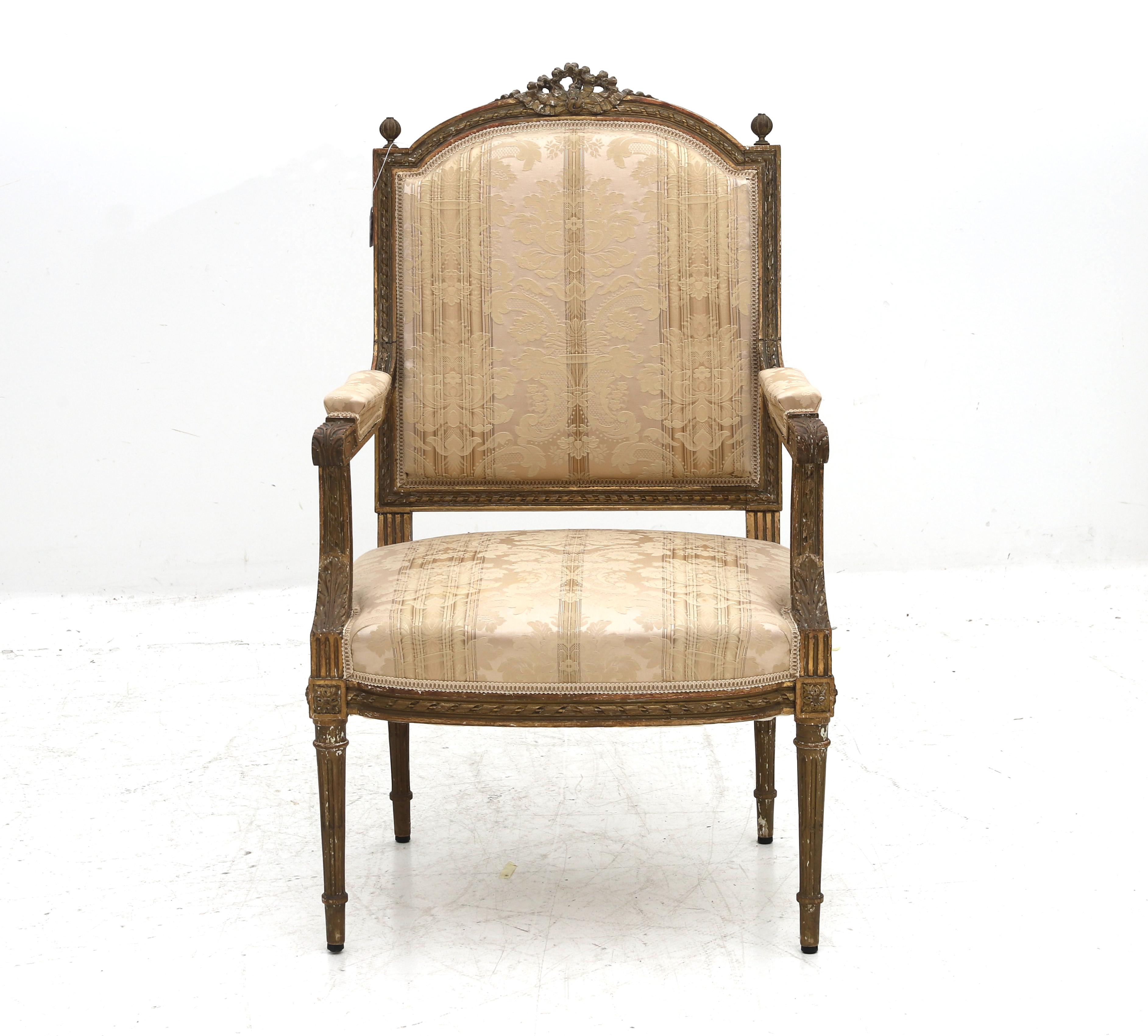 A Bergère in the Louis XVI style from France from the 19th century. Backrest topped with carved