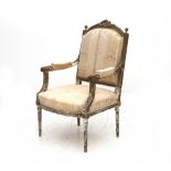 A Bergère in the Louis XVI style from France from the 19th century. Backrest topped with carved