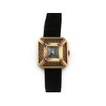 A 14 karat rose gold retro lady's wristwatch. Handwind movement. A square cage shaped case with a