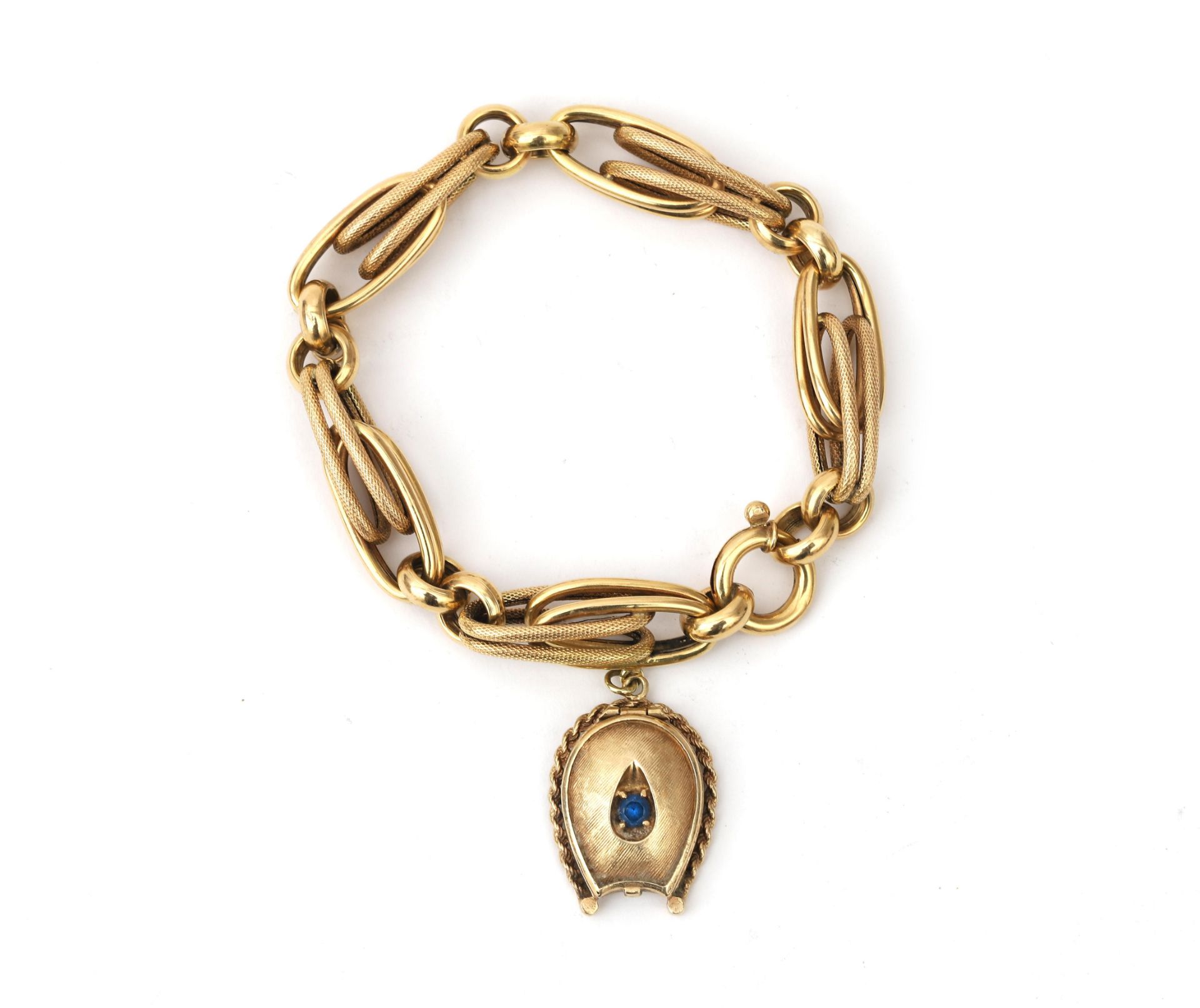 A 14 karat gold link bracelet with a gold locket. The locket is set with a blue paste stone. Oval