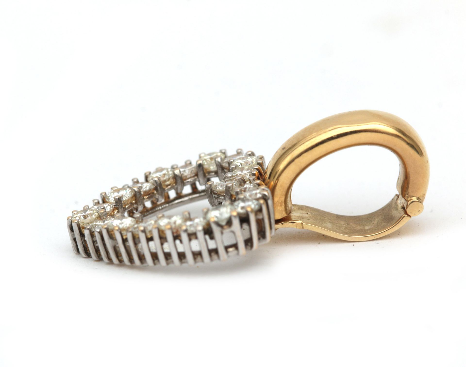 A 14 karat gold diamond set heart shaped pendant. Featuring twenty brilliant cut diamonds, ca. 1. - Image 2 of 3