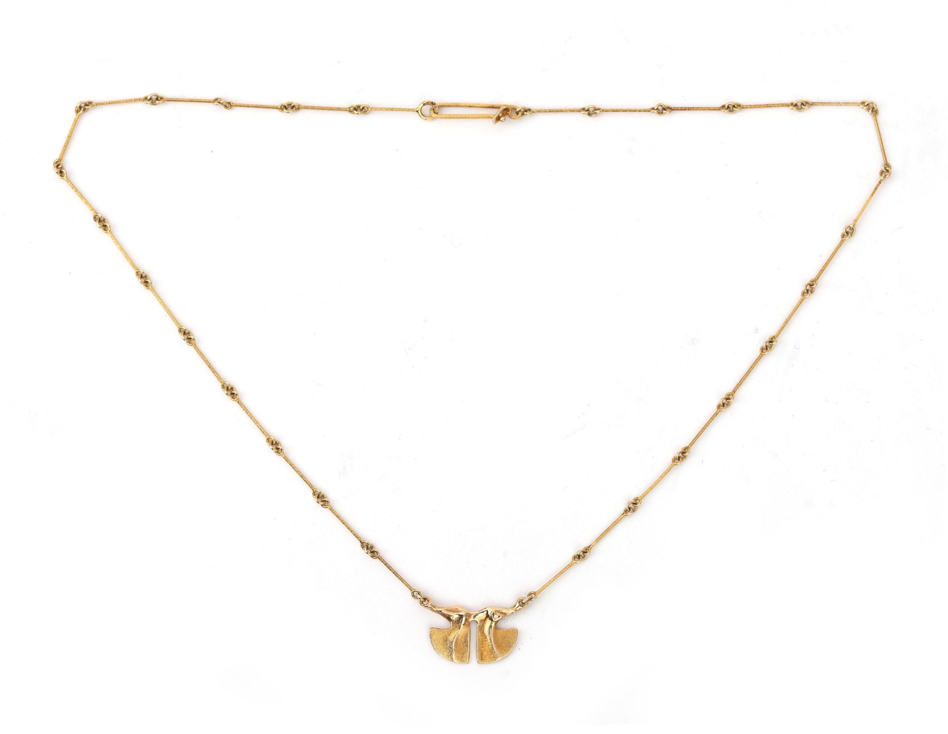 A 14 karat gold Lapponia necklace. An organic designed pendant, partly satiated gold suspended