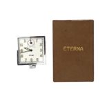 A steel Eterna automobile clock, ca. 1950. 8 days alarm, Incl. shop tags and box.