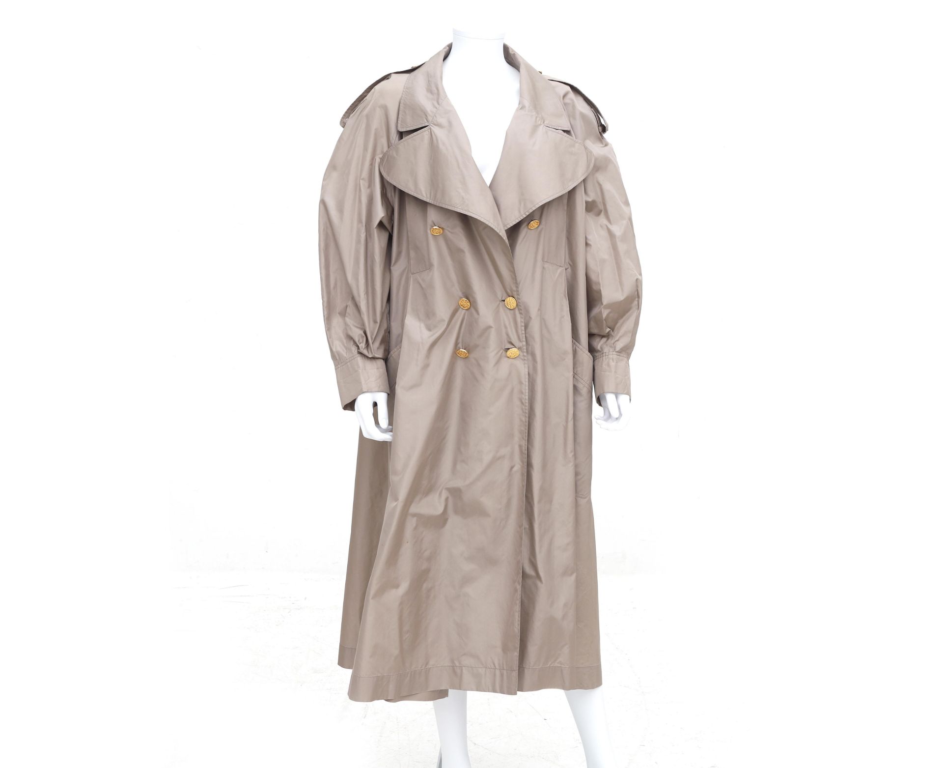 A camel Chanel Boutique trench coat. Comes with a matching belt and has gold coloured 'Coco'