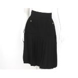 A Chanel Boutique skirt black with pleats at the bottom. The skirt has two external pockets with