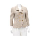 A beige Chanel Boutique jacket. Incl. fabric sample & buttons. The jacket has two external pockets
