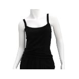 A Chanel Boutique tank top. The tank top has wide shoulder straps and flower-shaped buttons at the