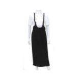 A black Chanel Boutique skirt with shoulder straps. The long skirt has two internal pockets on the