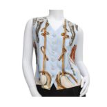 A light blue silk Hermès waistcoat. Elaborated with equestrian motifs and mother of pearl Hermès