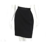 A black Chanel pencil skirt with stripe details down the length of the skirt. With two golden waffle