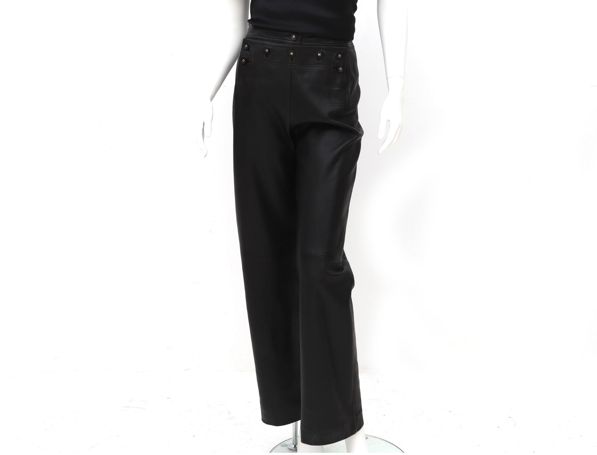 Chanel Boutique black leather pants. The pants have black with gold-colored CC logo buttons at the