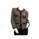 A brow/beige wool Chanel Boutique coat. With symmetrical pattern, a spread collar and on the front