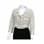 A light blue Chanel Boutique jacket. The edges of the jacket are made of white silk, and the