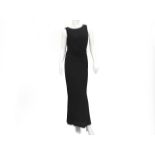 A black Chanel Boutique evening wrap dress. The dress is made with a V neckline and three CC logo