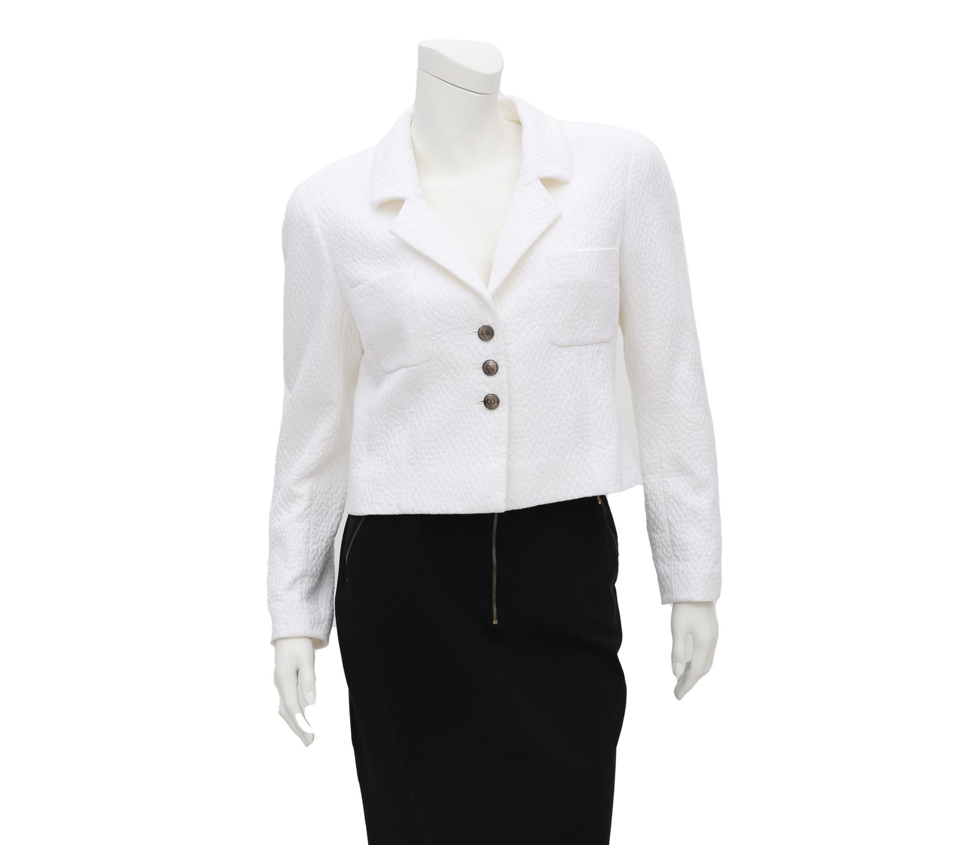 Chanel Boutique white jacket with a quilted pattern. The jacket has two external pockets, a