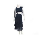 A navy blue Boutique ensemble. Composed of a short top that cab be worn with two bows at the