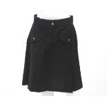 A black Chanel a-line pleated skirt. The skirt has two pockets with gold tone Chanel Paris
