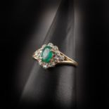 A Ladies 14KG Diamond and Emerald Ring