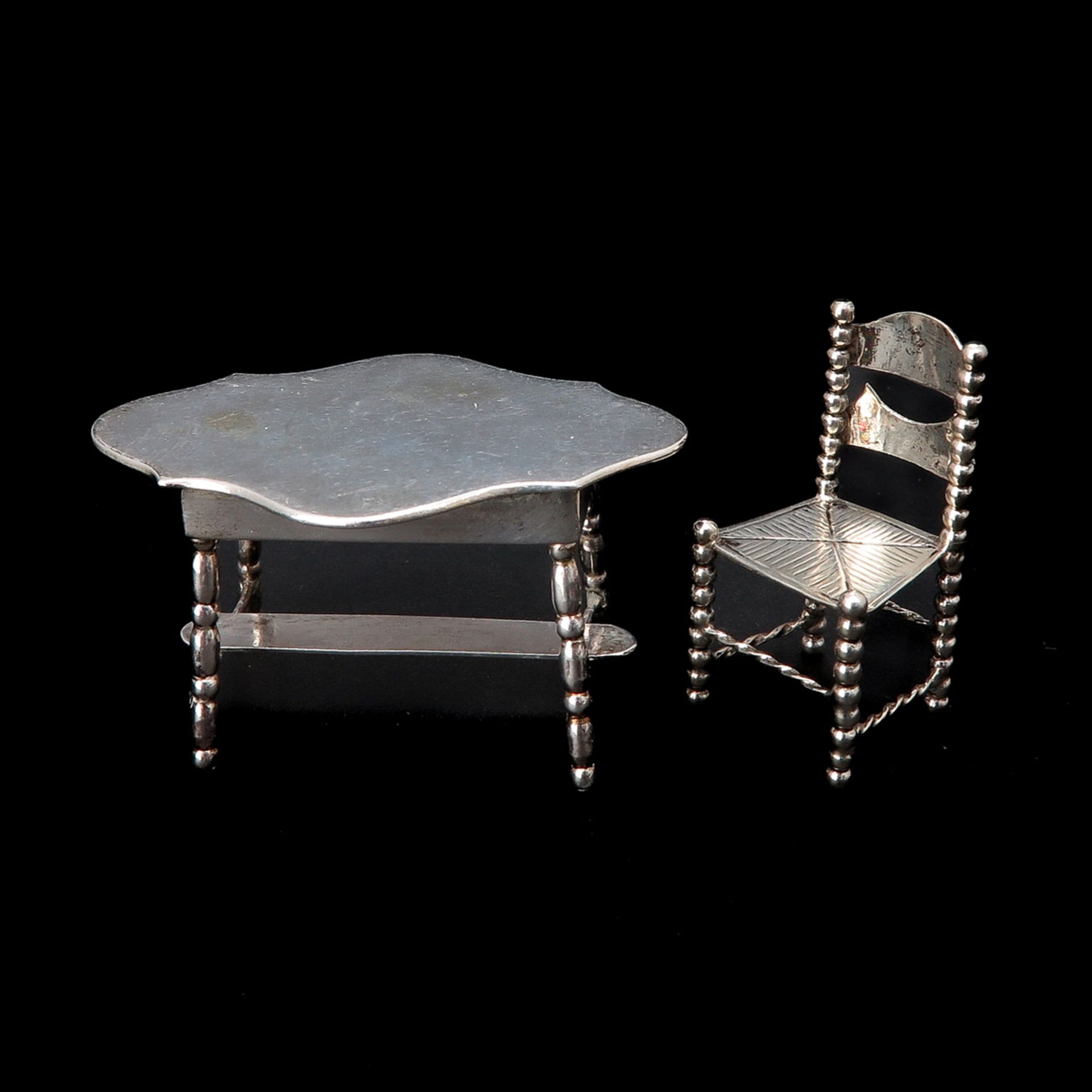 A Miniature Silver Table and Chair