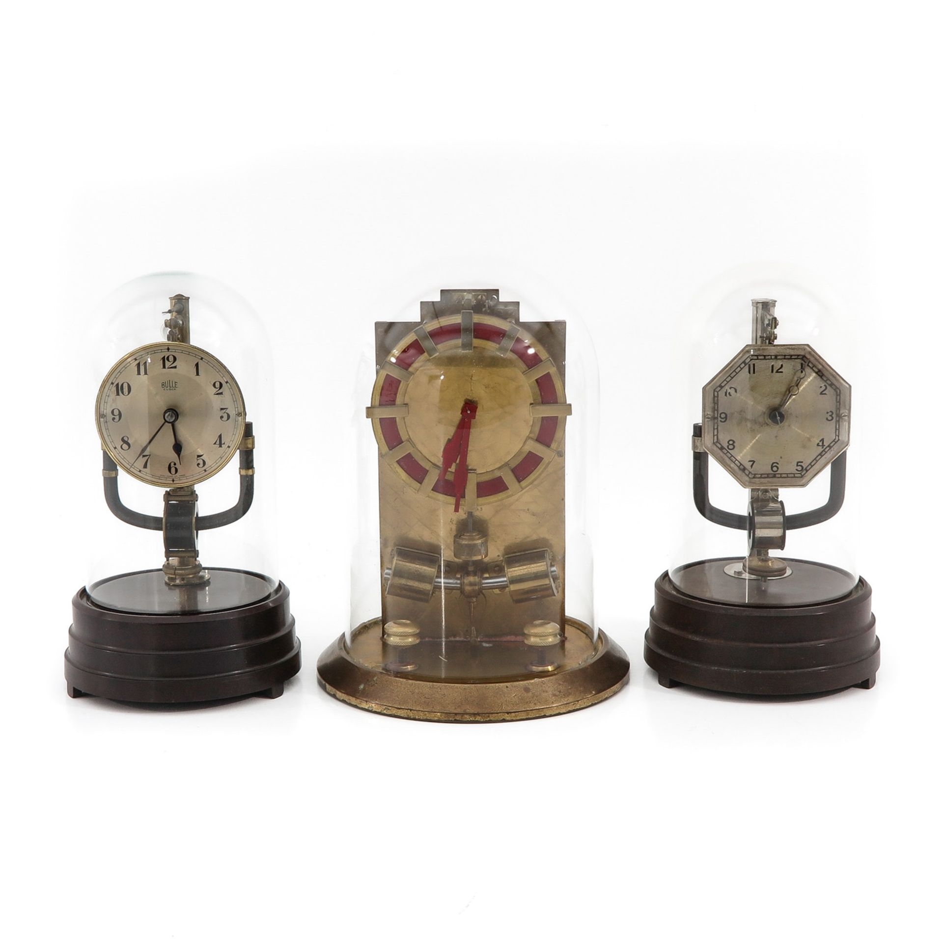 A Collection of 3 Electric Clocks under Glass Domes