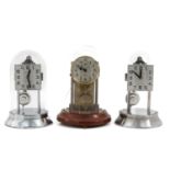 A Collection of 3 Electric Clocks Under Glass Domes