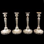 A Collection of 4 Silver Louis XVI Style Candlesticks
