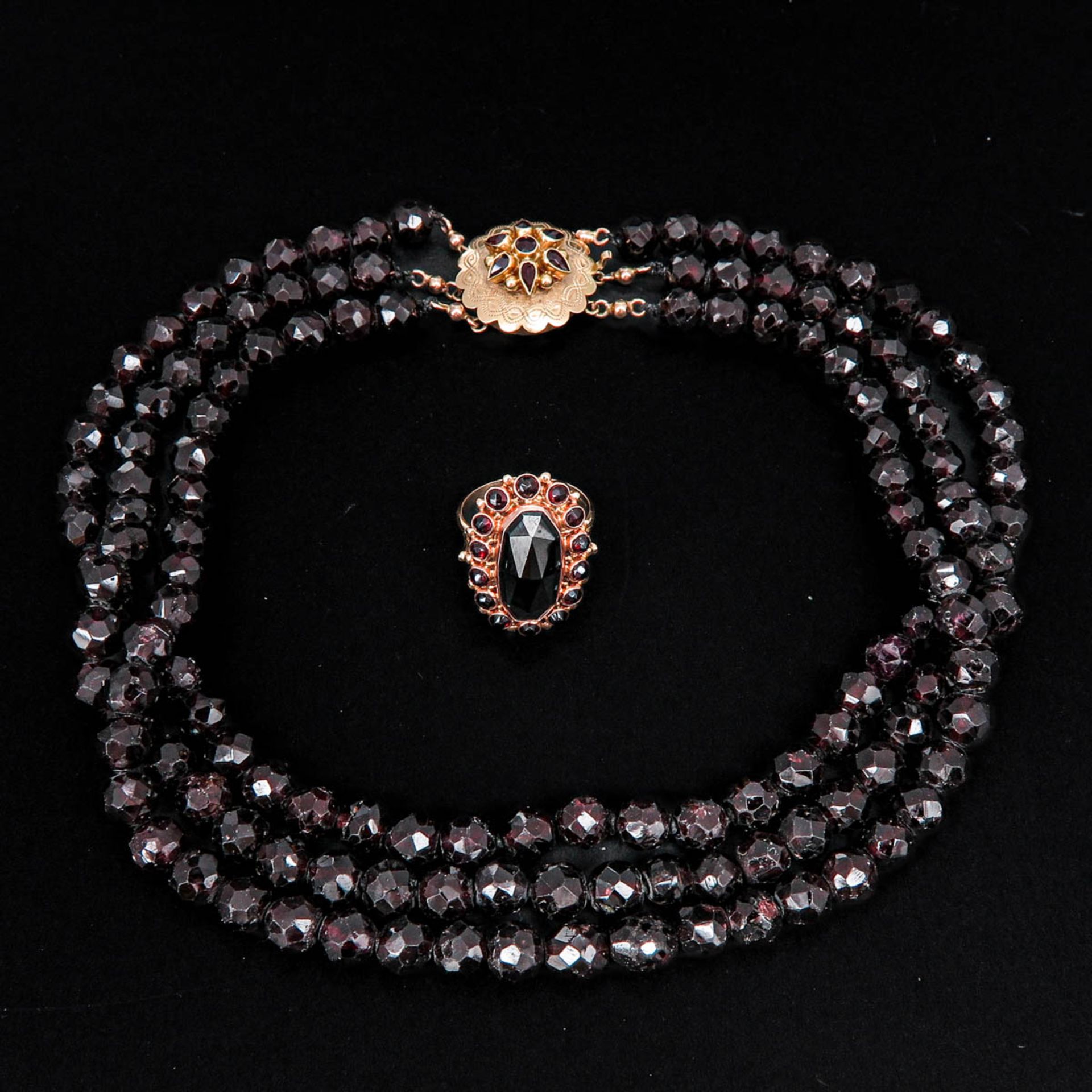 A Triple Strand Garnet Necklace and 14KG Ring