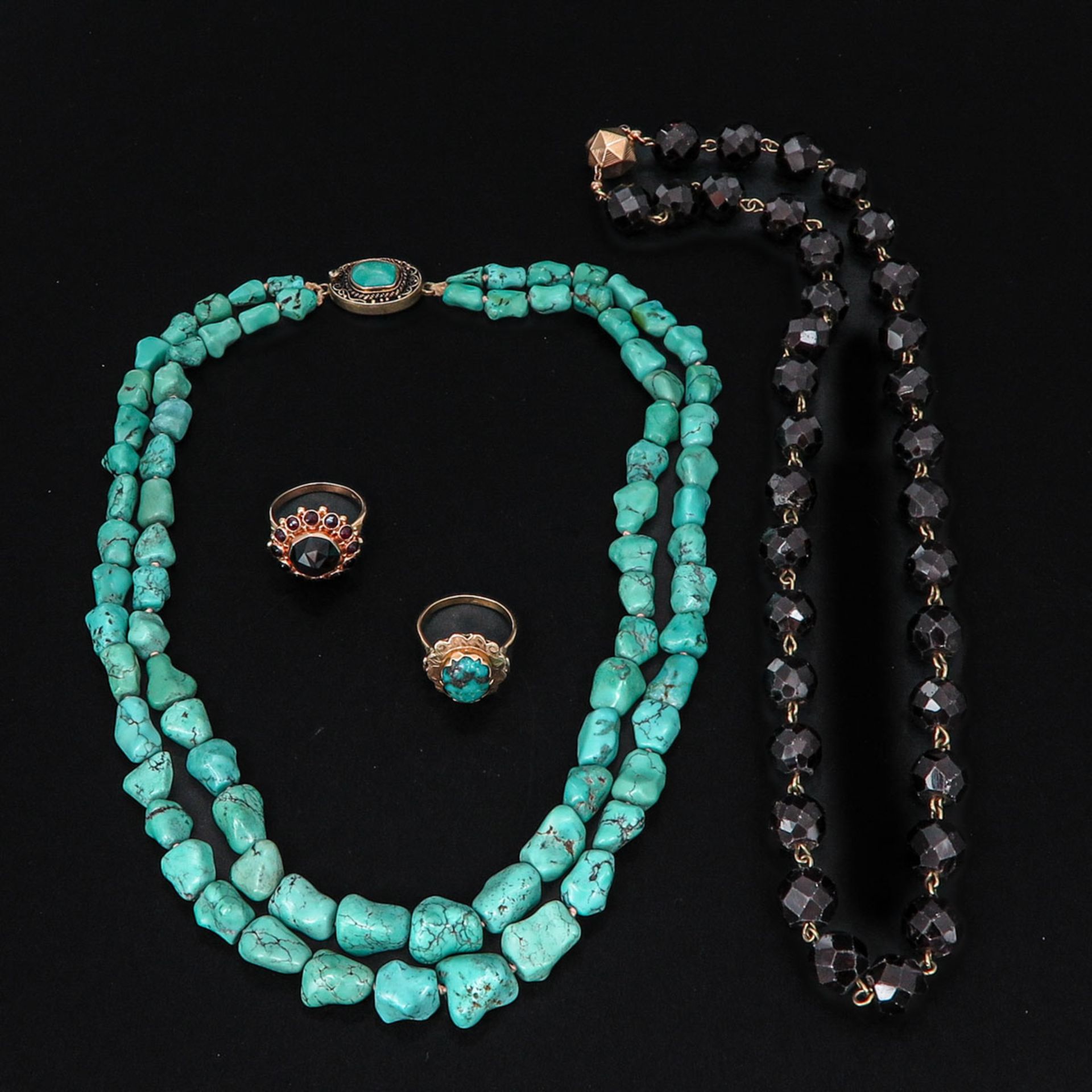A Turquoise Necklace and Ring along with a Garnet Necklace and Ring
