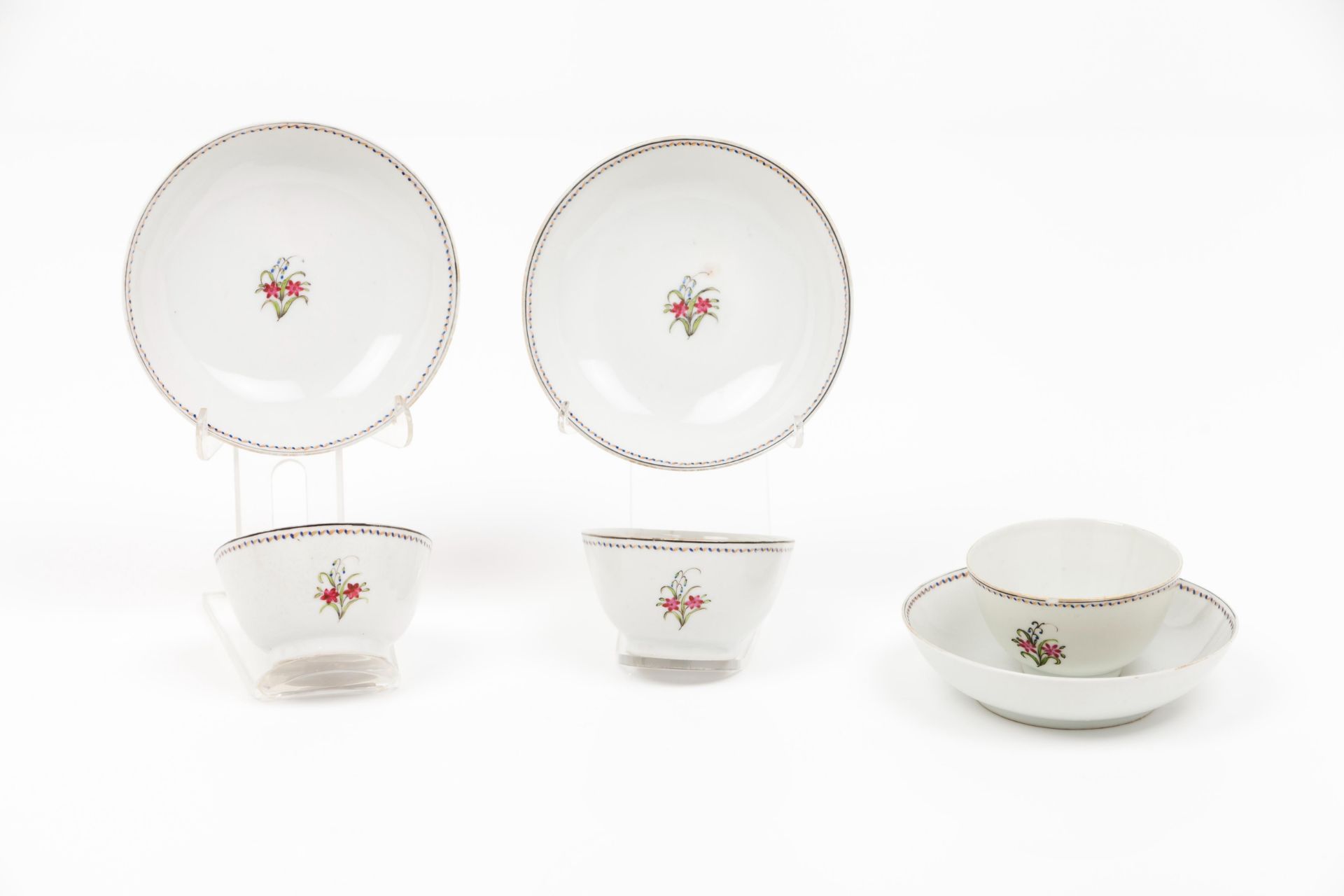 A set of three cups and saucers