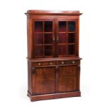 A cupboardMahogany Two sections Upper section with glazed doors and lower section with two drawers