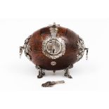 A Spanish colonial money box, 'Alcancia'Carved coconut Decorated with foliage scrolls and