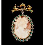 A brooch/pendantGold Bow and ribbons with cameo pendant of carved shell female figure framed by